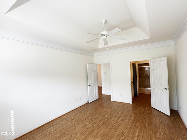4712 Fox Fern Ln, Raleigh, NC 27604 - unfurnished bedroom featuring wood finished floors, ornamental molding, baseboards, a tray ceiling, and ceiling fan