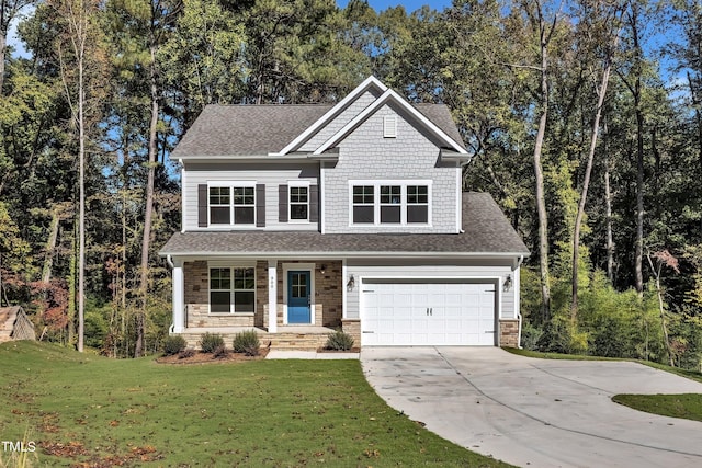 view of front of house with a shingled roof, a front lawn, stone siding, and driveway