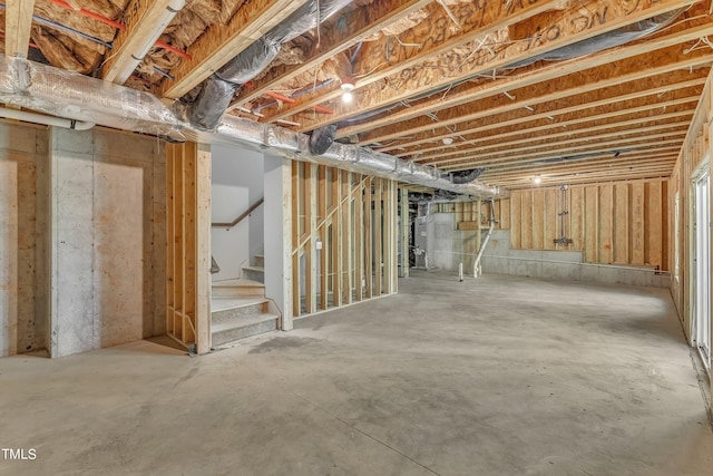 unfinished basement featuring stairs