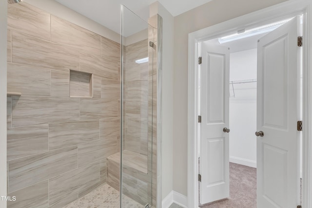 bathroom with a shower with door