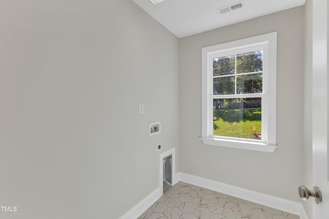 laundry area featuring hookup for an electric dryer, light tile patterned floors, washer hookup, and a wealth of natural light