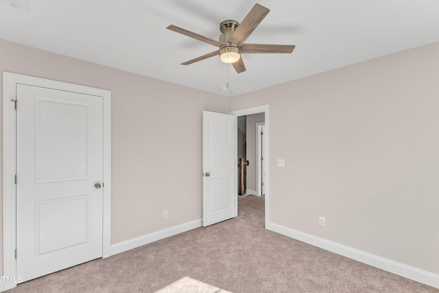 unfurnished bedroom featuring ceiling fan and light colored carpet