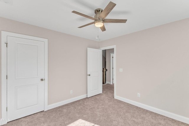 unfurnished bedroom featuring baseboards, a ceiling fan, and carpet
