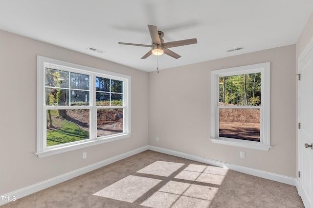 empty room with light colored carpet and ceiling fan