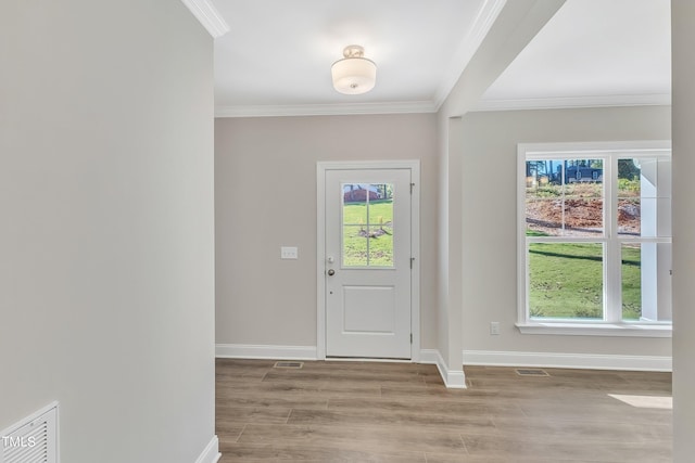 entryway featuring ornamental molding and light hardwood / wood-style flooring