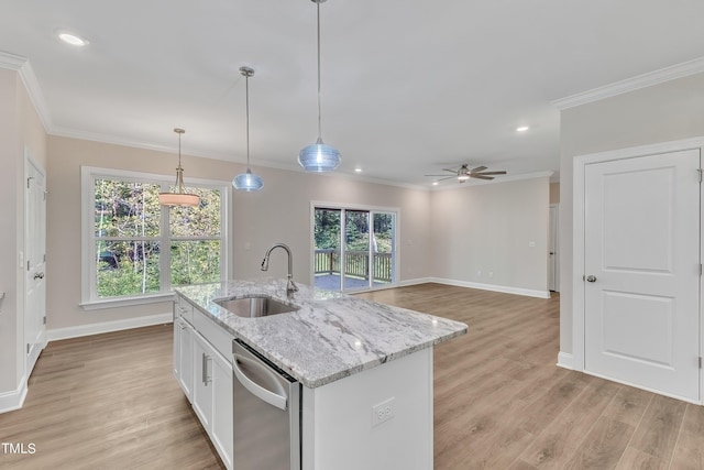 kitchen with light wood finished floors, crown molding, stainless steel dishwasher, and a sink