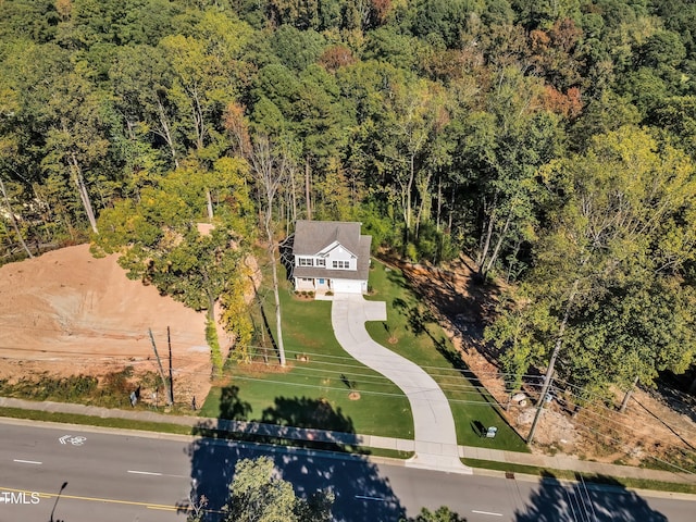 aerial view featuring a wooded view
