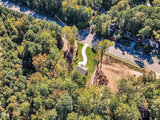 drone / aerial view with a wooded view