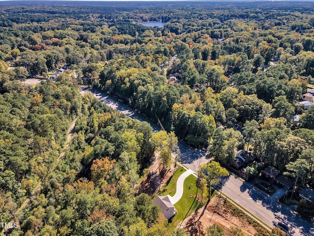 birds eye view of property with a view of trees