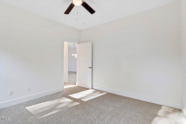 empty room with carpet flooring and ceiling fan