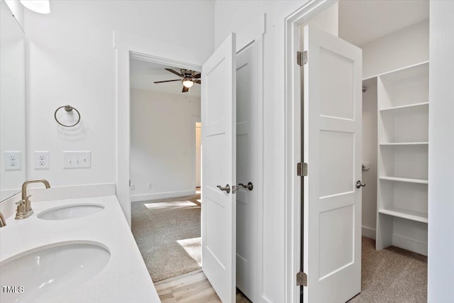 bathroom featuring vanity, ceiling fan, and wood-type flooring