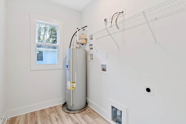 laundry room with light hardwood / wood-style floors, hookup for an electric dryer, water heater, and washer hookup