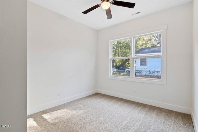 empty room with ceiling fan and carpet