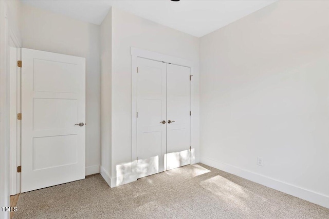 unfurnished bedroom featuring a closet and carpet