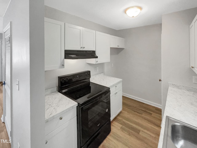 kitchen featuring light hardwood / wood-style floors, sink, black range with electric stovetop, light stone countertops, and white cabinets