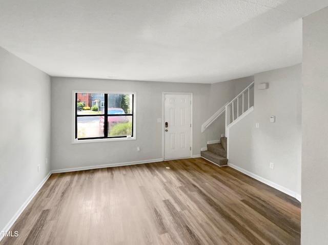 interior space with hardwood / wood-style flooring and a textured ceiling