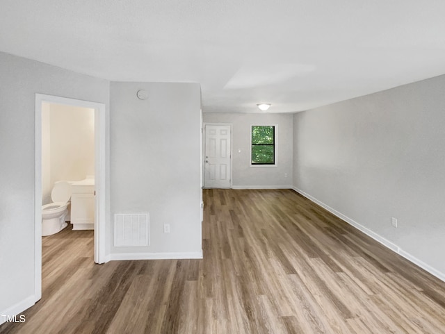 unfurnished room with hardwood / wood-style floors