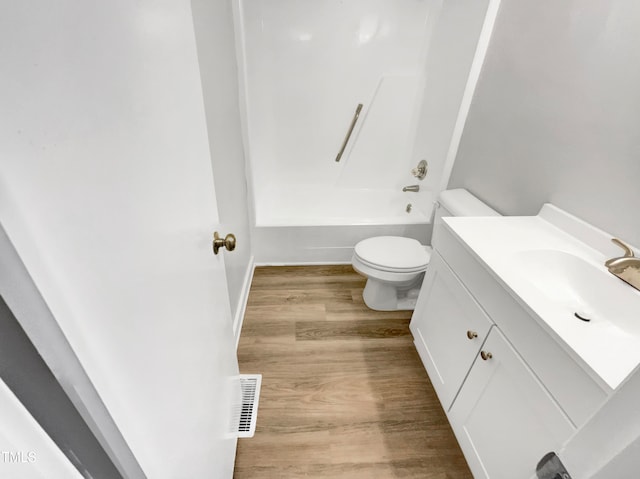 full bathroom with toilet, tub / shower combination, hardwood / wood-style flooring, and vanity