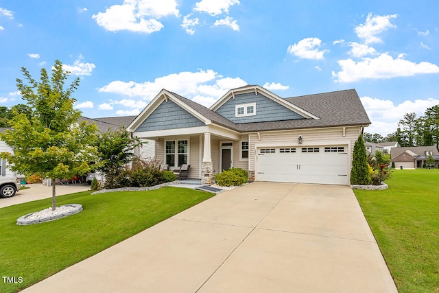 craftsman house featuring a garage, a front yard, and covered porch