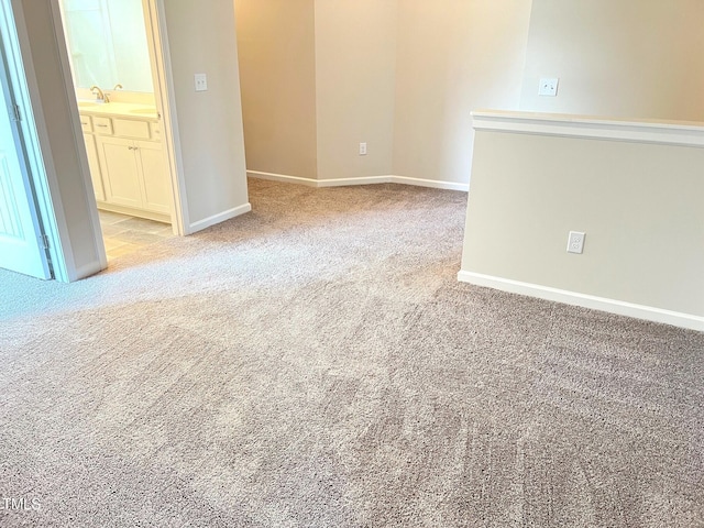 empty room with light colored carpet and baseboards