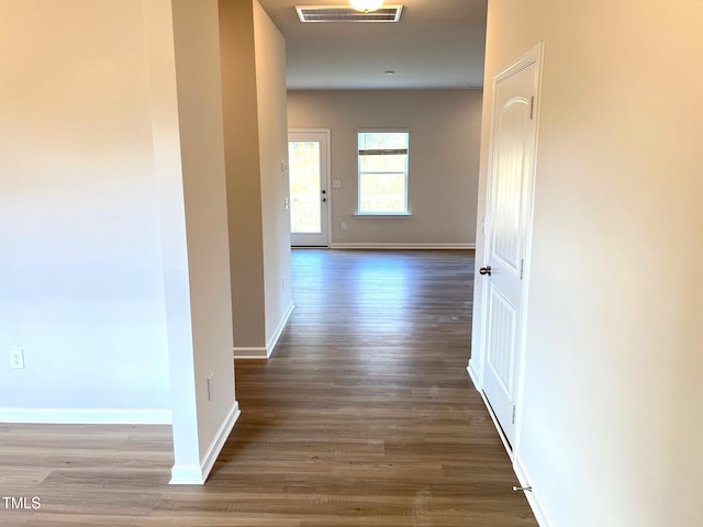 hall featuring wood finished floors and baseboards