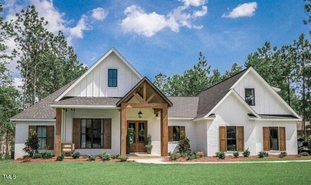 modern farmhouse style home with a front lawn