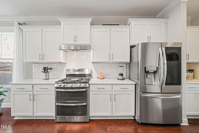 kitchen featuring white cabinetry, dark wood-type flooring, tasteful backsplash, stainless steel appliances, and extractor fan