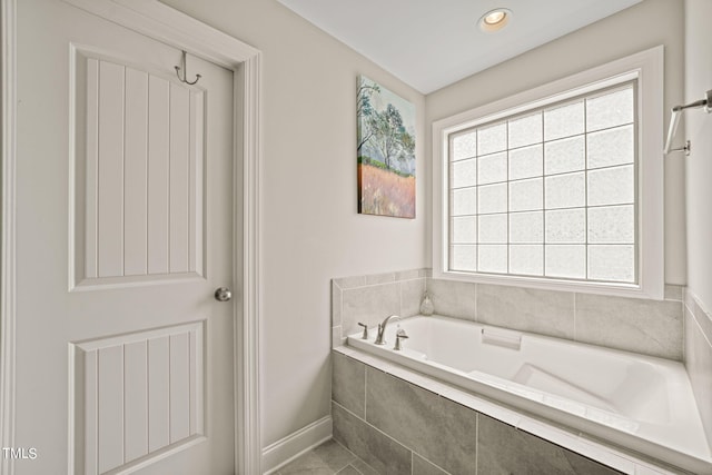 bathroom featuring tiled tub