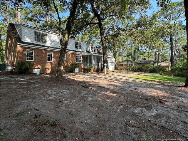 rear view of house with a sunroom