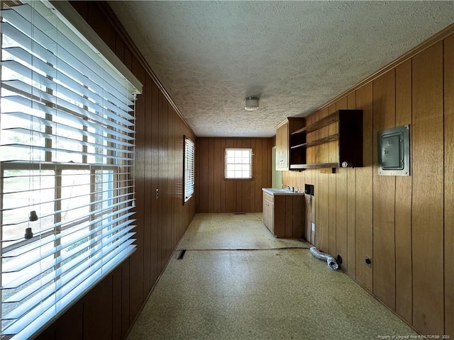 interior space featuring electric panel and a textured ceiling