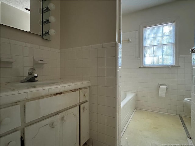 bathroom with tile walls and vanity