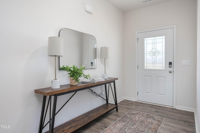 foyer with visible vents, baseboards, and wood finished floors