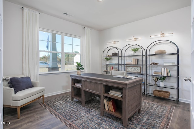 home office with dark wood-style flooring, visible vents, and baseboards