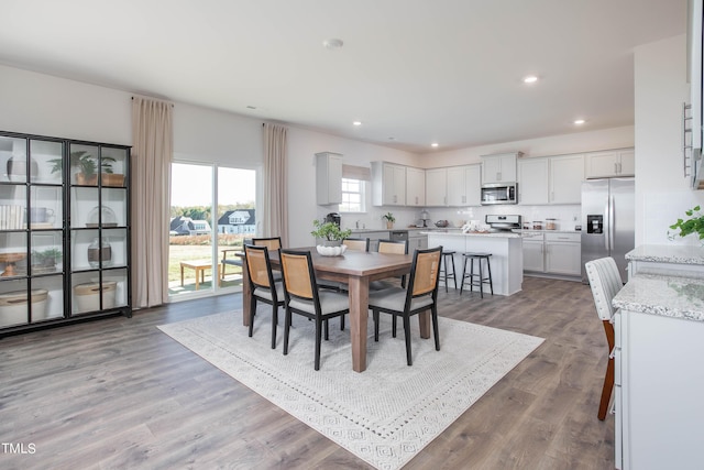 dining area with recessed lighting and wood finished floors