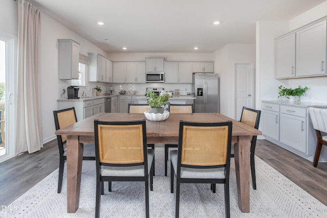 dining room featuring dark wood finished floors and recessed lighting