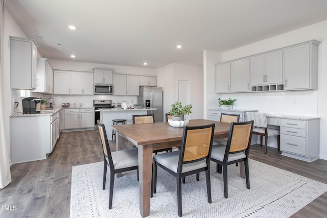 dining room with dark wood-type flooring and recessed lighting