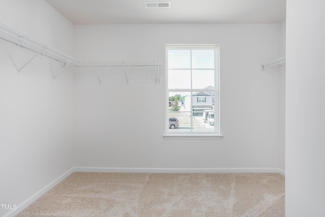 walk in closet with carpet floors and visible vents