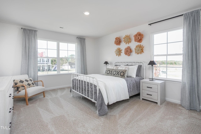 bedroom featuring multiple windows, carpet, and baseboards