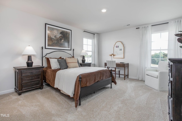 bedroom featuring recessed lighting, light colored carpet, baseboards, and multiple windows