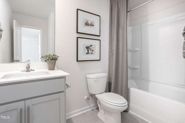 bathroom with baseboards, vanity, toilet, and shower / bath combo with shower curtain