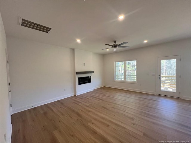 unfurnished living room featuring hardwood / wood-style floors and ceiling fan