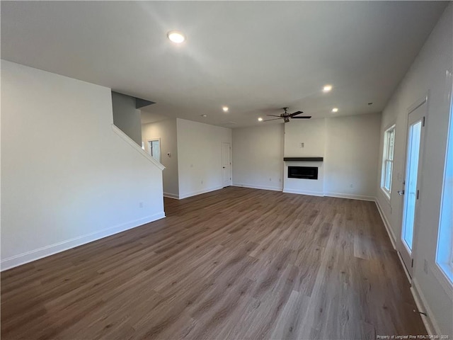 unfurnished living room featuring light hardwood / wood-style flooring and ceiling fan