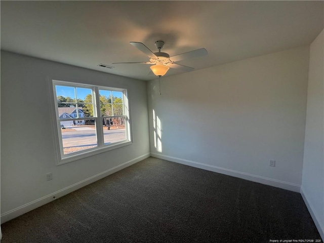 empty room featuring carpet floors and ceiling fan