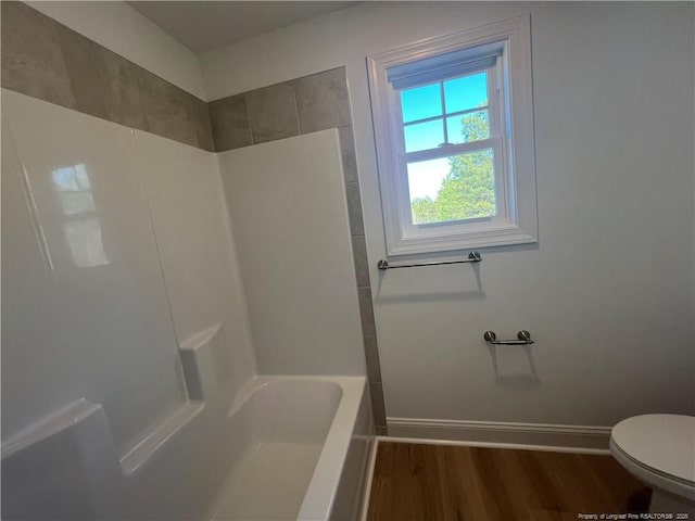 bathroom with hardwood / wood-style flooring and toilet