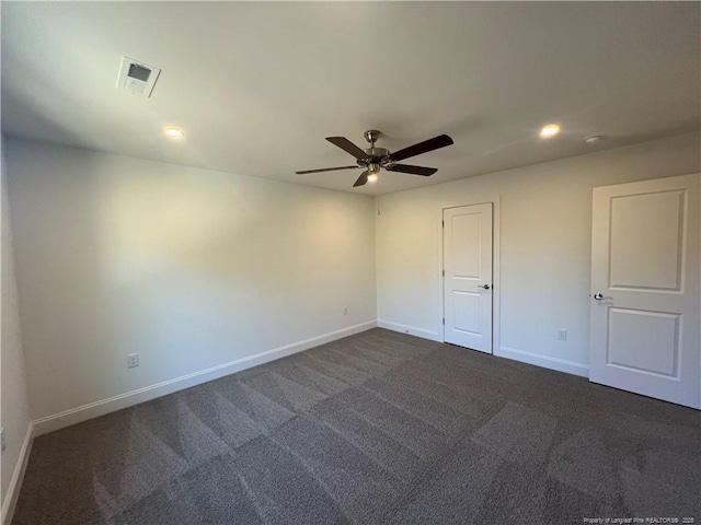 unfurnished room featuring dark carpet and ceiling fan