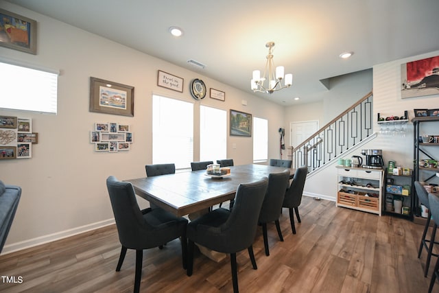 dining space featuring a notable chandelier and dark hardwood / wood-style floors