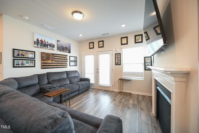 living room with light hardwood / wood-style floors and french doors