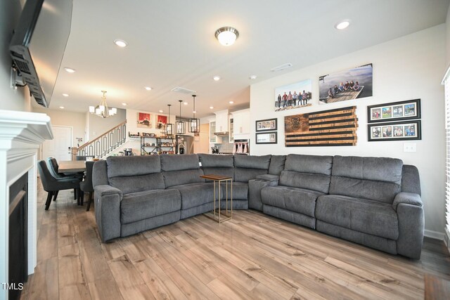 living room featuring light hardwood / wood-style flooring and a chandelier