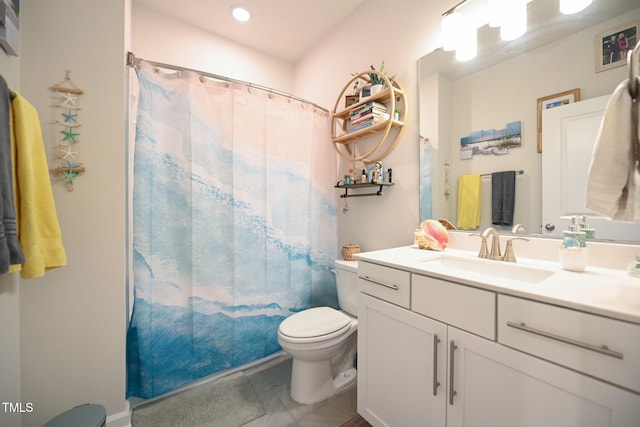 bathroom featuring tile patterned flooring, toilet, and vanity