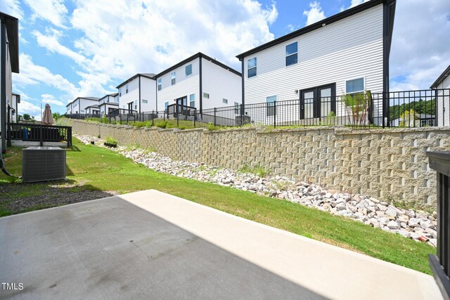 view of yard featuring central AC unit and a patio